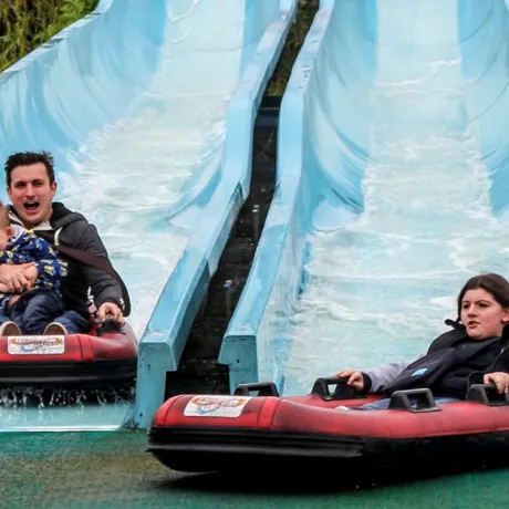 Kip Hakes and his family coming down the depth charge water slides