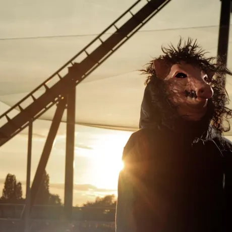 SAW pig head standing outside The Swarm
