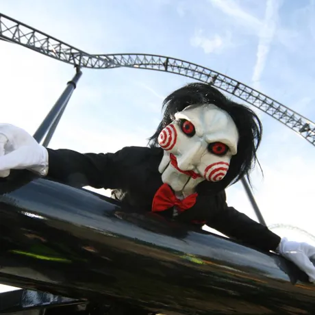 Billy doll from SAW laying on SAW rollercoaster track